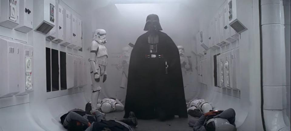 Darth Waver standing inside a rebel ship with dead soldiers beneath him in "Star Wars: Episode IV - A New Hope"