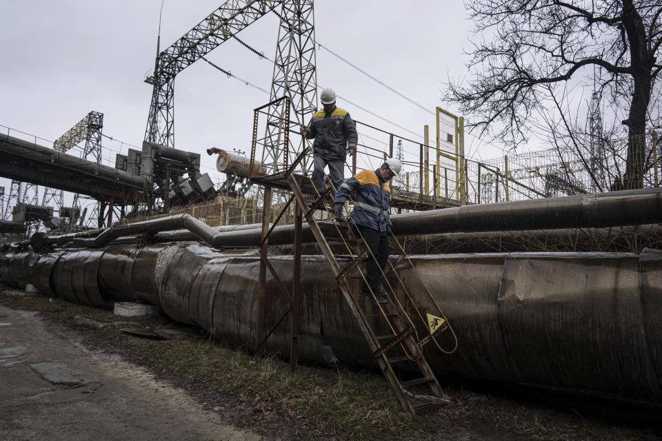 Power plant workers walk to repair damages after a Russian attack in central Ukraine, Thursday, Jan. 5, 2023. When Ukraine was at peace, its energy workers were largely unheralded. War made them heroes. They're proving to be Ukraine's line of defense against repeated Russian missile and drone strikes targeting the energy grid and inflicting the misery of blackouts in winter. (AP Photo/Evgeniy Maloletka)