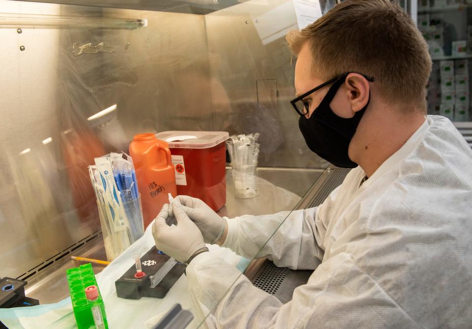 A May 2020 photo from Eglin Air Force Base shows a 96th Medical Group laboratory technician handling a patient sample to test for COVID-19. An uptick in COVID-19 cases in the area has prompted Eglin AFB and other area military installations to institute stricter COVID-19 mitigation protocols.