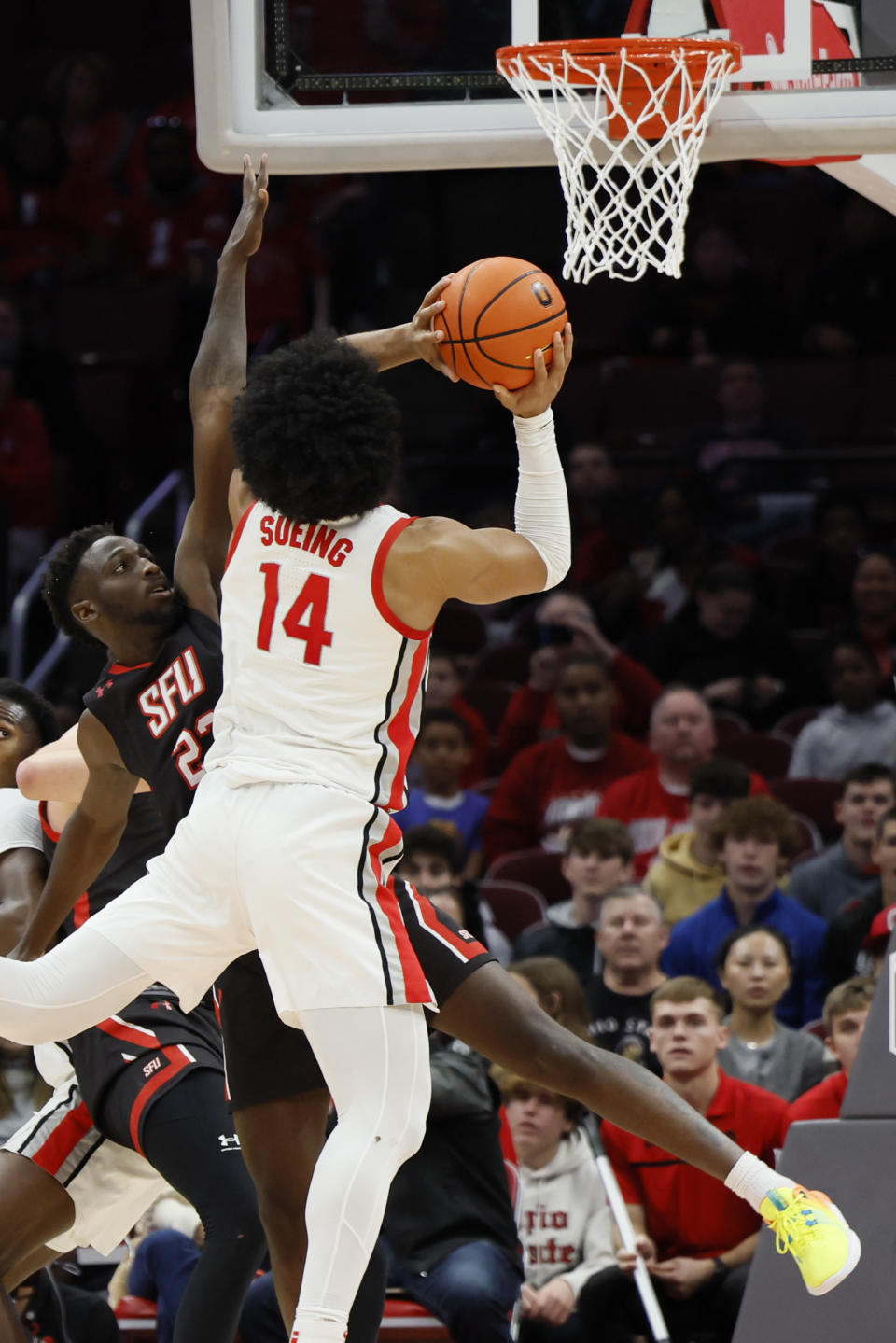 Ohio State's Justice Sueing, front, tries to shoot over Saint Francis' Wisler Sanon during the first half of an NCAA college basketball game on Saturday, Dec. 3, 2022, in Columbus, Ohio. (AP Photo/Jay LaPrete)