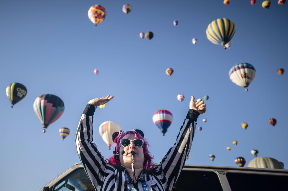 Launch Director Kat Brennan signals for a pilot to go ahead and take off Saturday, Oct. 7, 2023, during the Albuquerque International Balloon Fiesta in Albuquerque, N.M. (AP Photo/Roberto E. Rosales)