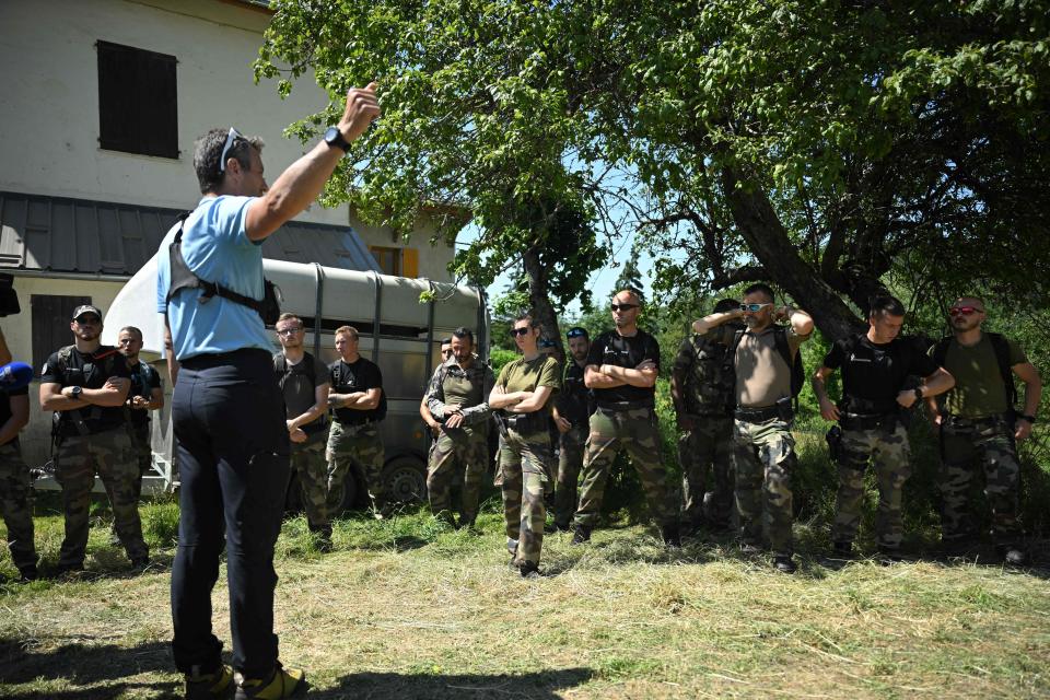 French gendarmes are briefed before taking part in a search operation for two-and-a-half-year-old Emile who is reported missing for two days, on 10 July (AFP via Getty Images)