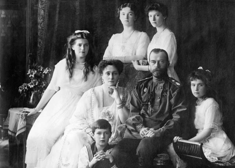 Photo shows members of the Romanovs, the last imperial family of Russia including: seated (left to right) Marie, Queen Alexandra, Czar Nicholas II, Anastasia, Alexei (front), and standing (left to right), Olga and Tatiana in 1913 or 1914. On February 6, 1928, a young woman claiming to be the slain Anastasia arrived in the United States. File Photo courtesy the Library of Congress