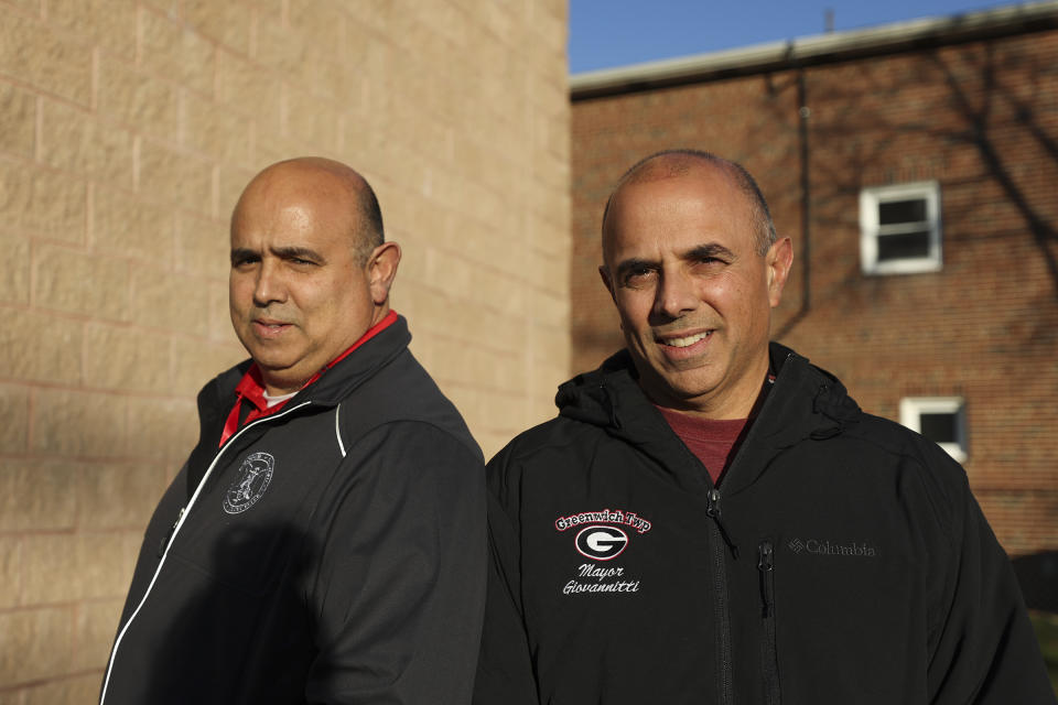 John Giovannitti, left, mayor-elect of Paulsboro, and brother Vince Giovannitti, mayor of Greenwich Township, stand together for a portrait outside of the Greenwich Township Municipal Building in Gibbstown, N.J., on Tuesday, Dec. 12, 2023. (Heather Khalifa/The Philadelphia Inquirer via AP)