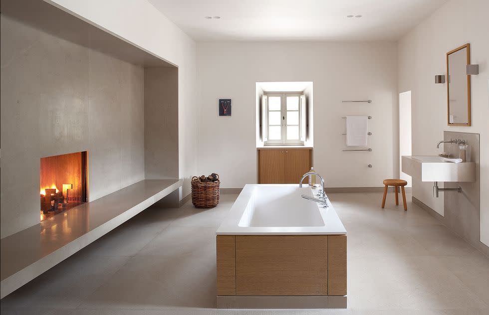 a bathroom with a tub sink and a mirror