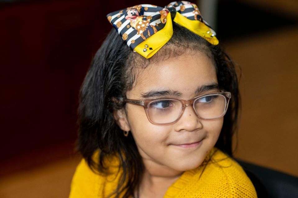 Aurelius-Rose Cox, 7, models a hairbow made by her mother Antinique Cox on Thursday, Nov. 11, 2021, inside Sherria's Place hair salon in Battle Creek, Michigan. Antinique Cox named her hairbow business "A Touch Of A. Rose Bowtique" after her daughter. 