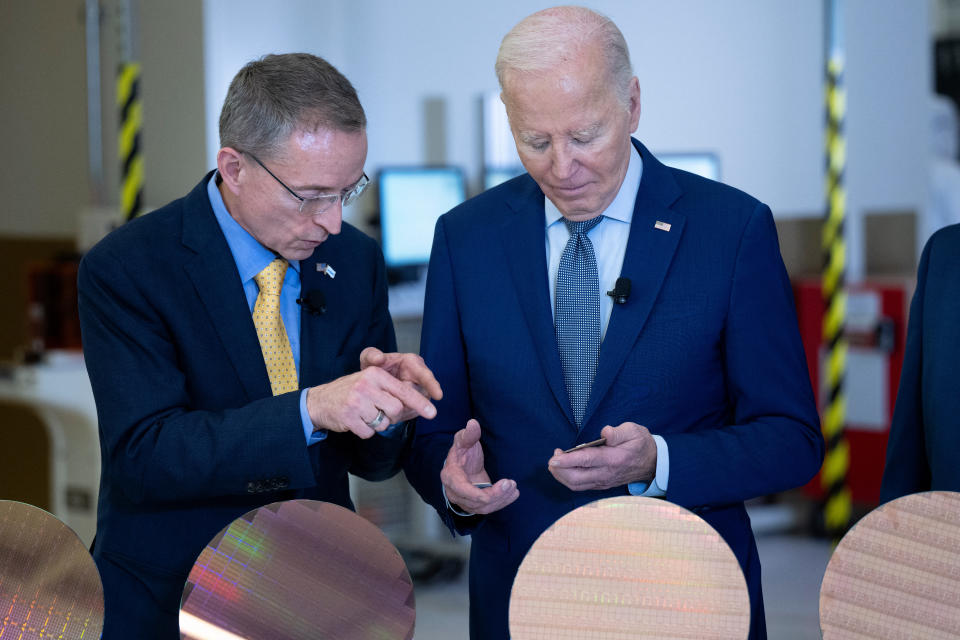 Intel CEO Pat Gelsinger shows U.S. President Joe Biden processors and semiconductor wafers during a tour of Intel's Ocotillo campus in Chandler, Arizona, March 20, 2024. The White House on Wednesday announced about $20 billion in new grants and loans to support Intel's U.S. chips. This is the Biden administration's largest funding announcement yet as it seeks to counter China's dominance in critical technologies.  (Photo by BRENDAN SMIALOWSKI/AFP) (Photo by BRENDAN SMIALOWSKI/AFP via Getty Images)