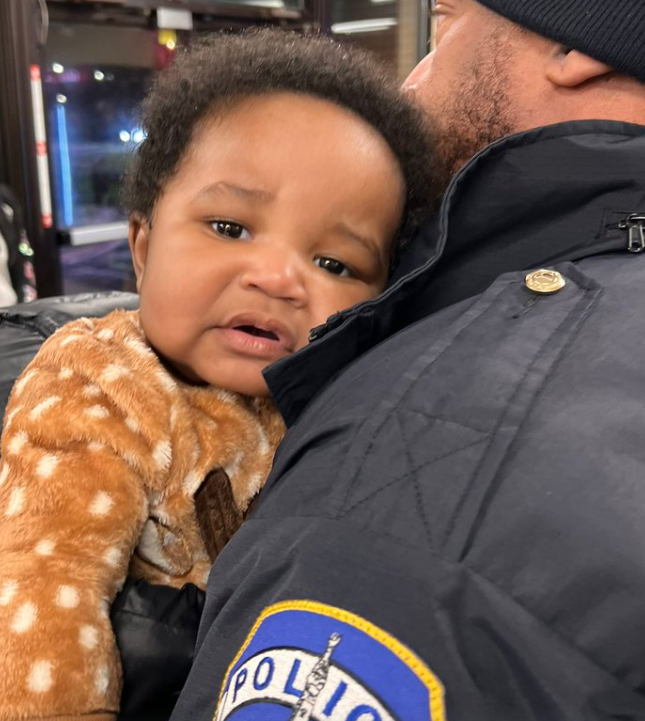 Five-month-old Kason Thomas being held by an Indianapolis Metropolitan Police Department officer after he was found at 6:46 p.m. Thursday inside his mother's stolen Honda Accord that had been left in the parking lot of a Papa John's pizza in Indianapolis. A gift drive is taking place Saturday for the twins, both of whom are now back in Columbus.