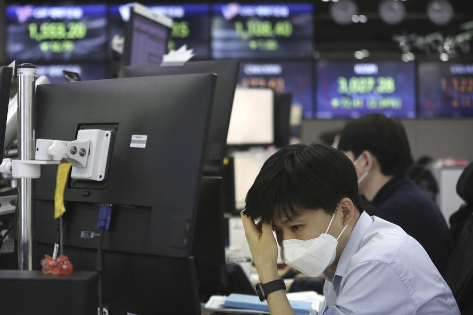 A currency trader watches monitors at the foreign exchange dealing room of the KEB Hana Bank headquarters in Seoul, South Korea, Friday, Feb. 26, 2021. Asian shares skidded Friday after rising bond yields triggered a broad sell-off on Wall Street that erased the markets gain for the week and handed the Nasdaq composite index its steepest loss since October. (AP Photo/Ahn Young-joon)