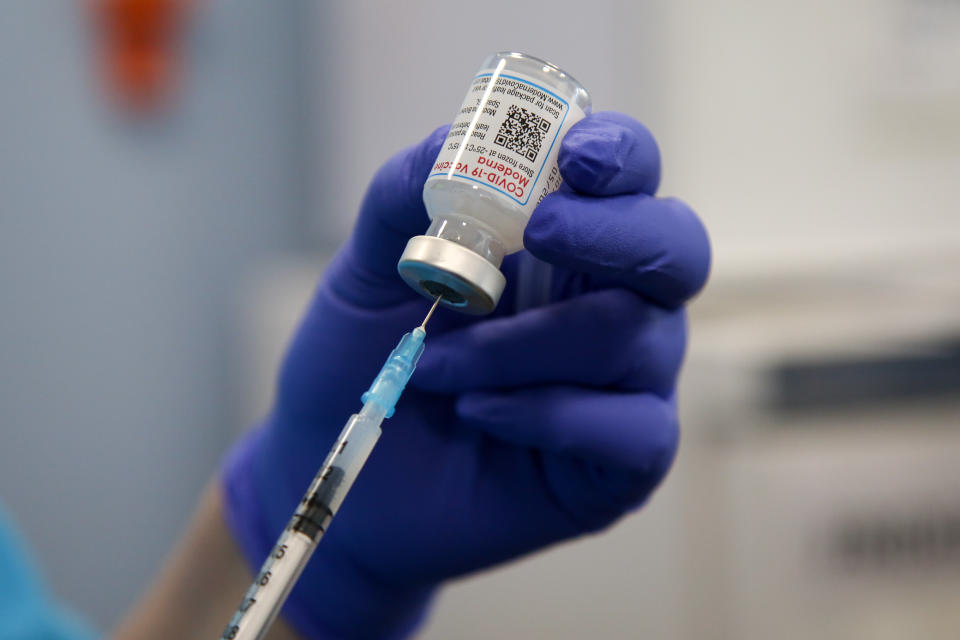 LONDON, UNITED KINGDOM - 2022/04/22: A health worker draws the Moderna COVID-19 vaccine as she prepares to administer the spring booster also known as fourth jab to a person at a vaccination clinic. (Photo by Dinendra Haria/SOPA Images/LightRocket via Getty Images)