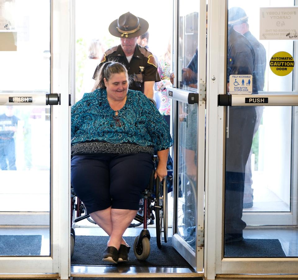 Danni Legg is assisted through the doors to attend the Sept. 28 Oklahoma State Board of Education meeting.