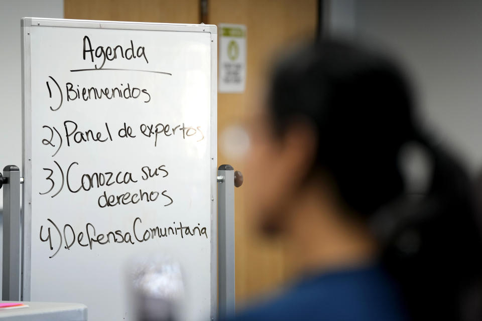 A woman listens to a speaker during an Iowa Migrant Movement for Justice informational meeting, Wednesday, March 27, 2024, in Des Moines, Iowa. A bill in Iowa that would allow the state to arrest and deport some migrants is stoking anxiety among immigrant communities about how it would be interpreted and enforced. (AP Photo/Charlie Neibergall)