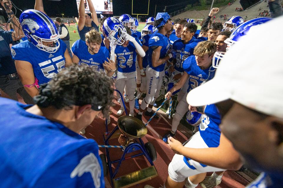 The Pueblo Central football ring the bell on the sideline after winning the 2021 Bell Game against Pueblo Centennial on Friday October 8, 2021 at Dutch Clark Stadium.