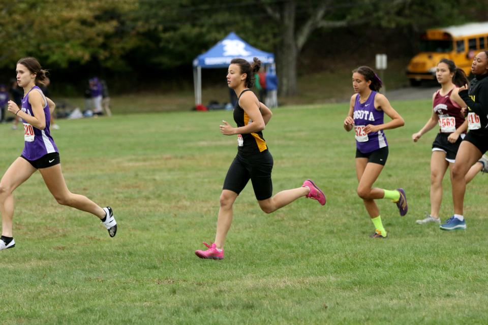 Danielle Tilp (black and yellow), of Cresskill, is shown just behind Amandine Fernandez, of Bogota during the first 200 meters of the Patriot race.  Tilp would go on to win the race in 20:42, six seconds in front of Fernandez, who came in second place. Monday, October 3, 2022