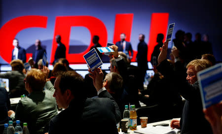 Delegates vote during a Christian Democratic Union (CDU) party congress in Berlin, Germany, February 26, 2018. REUTERS/Hannibal Hanschke