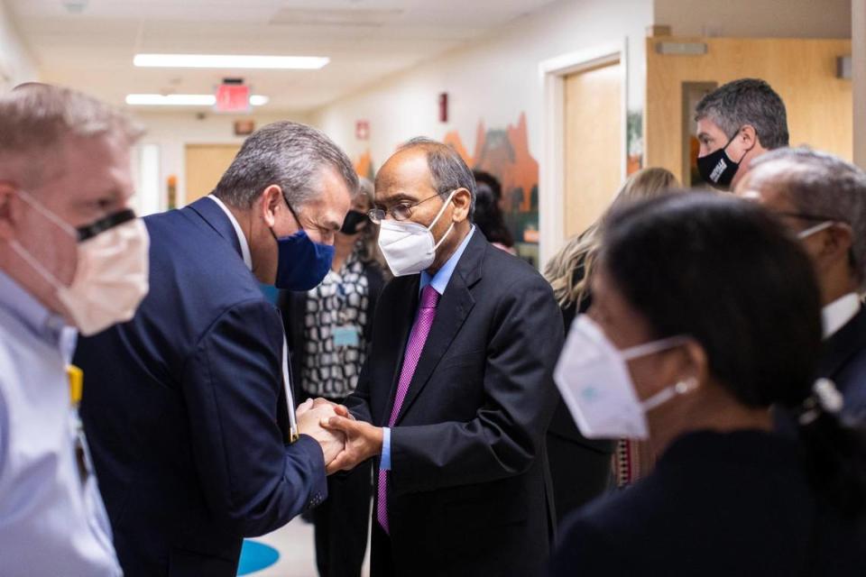 President Donovan Blackburn shake hands while talking with Dr. R.V. Mettu during an opening ceremony for the Mettu Children’s Hospital at Pikeville Medical Center in Pikeville, Ky., Thursday, December 2, 2021.