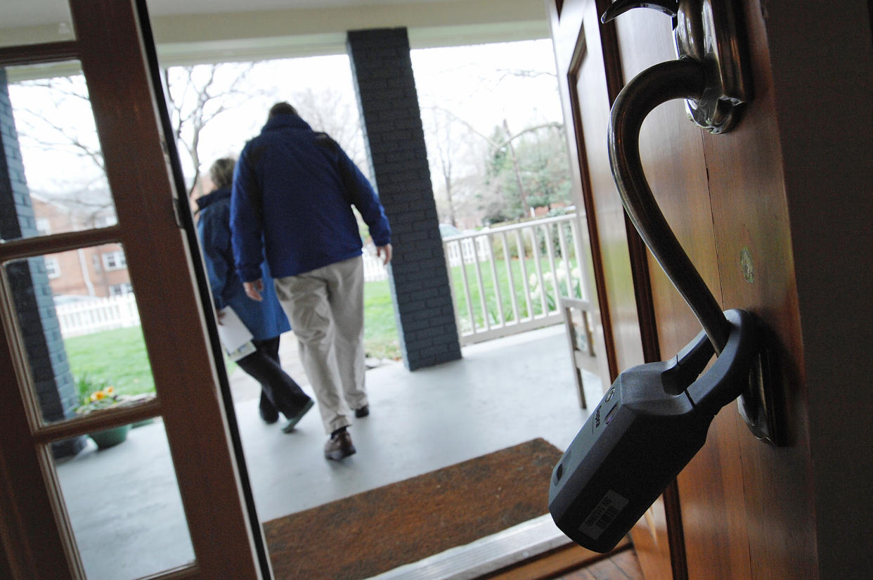 A realtor's lock box hangs on a door as prospective buyers depart an open house for sale in Alexandria, Virginia. (Credit: Jonathan Ernst, REUTERS)  