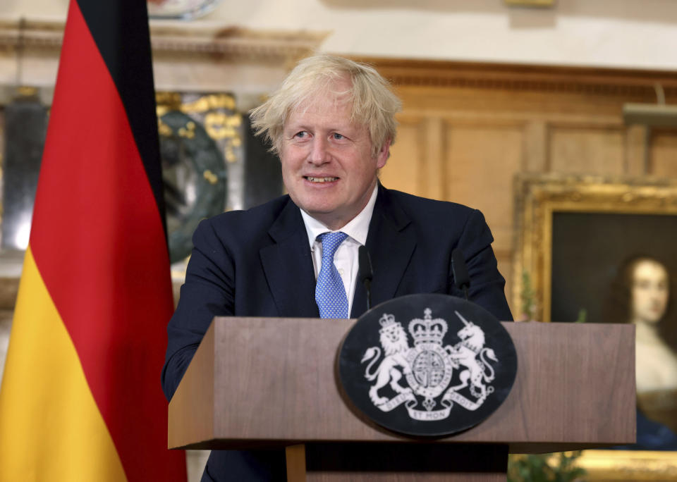 Britain's Prime Minister Boris Johnson takes part in a press conference with German Chancellor Angela Merkel, after their meeting at Chequers, the country house of the Prime Minister, in Buckinghamshire, England, Friday July 2, 2021. Johnson is likely to push Angela Merkel to drop her efforts to impose COVID-19 restrictions on British travelers as the German chancellor makes her final visit to Britain before stepping down in the coming months. Johnson will hold talks with Merkel at his country residence on Friday. (Jonathan Buckmaster//Pool Photo via AP)