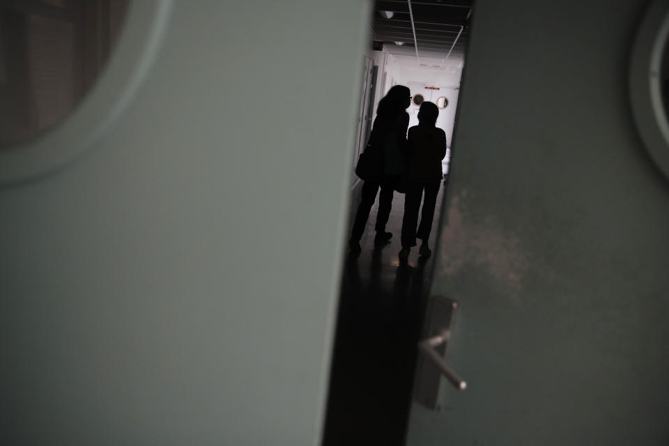 A young girl walks with her mother inside the pediatric unit of the Robert Debre hospital, in Paris, France, Wednesday, March 3, 2021. Doctors say the impact of the coronavirus pandemic on the mental health of children is alarming and plain to see. France's busiest pediatric hospital has seen a doubling in the number of children and young teenagers requiring treatment after attempted suicides.(AP Photo/Christophe Ena)