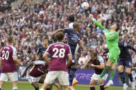 West Ham's goalkeeper Lukasz Fabianski, in green, makes a save during the English Premier League soccer match between West Ham United and Manchester City at London stadium in London, Sunday, May 15, 2022. (AP Photo/Kirsty Wigglesworth)