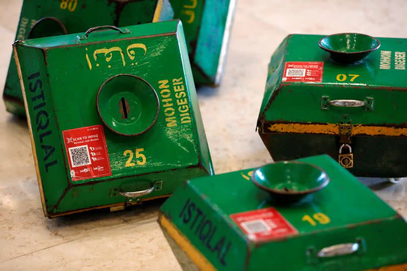 Alms boxes with QR codes for digital payments are seen after Friday prayers at Istiqlal mosque in Jakarta