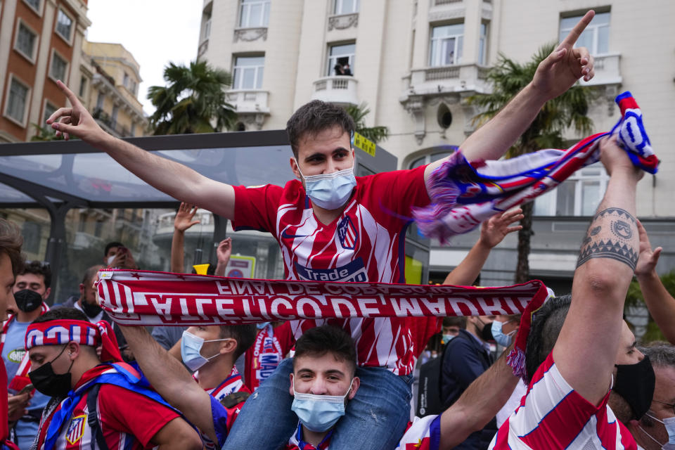 Atletico Madrid supporters celebrate their team's Spanish La Liga title in Madrid, Saturday, May 22, 2021. Atletico clinches its 11th Spanish La Liga title. (AP Photo/Paul White)