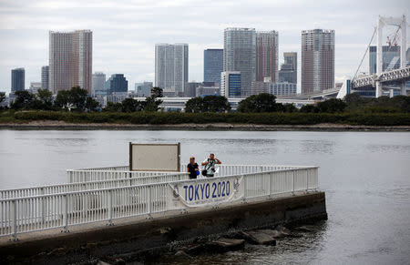 Visitors stroll at Odaiba Marine Park, the venue for Marathon Swimming and Triathlon events during the Tokyo 2020 Games, in Tokyo, Japan October 4, 2017. REUTERS/Issei Kato