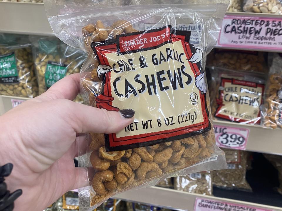 The writer holds Trader Joe's chile and garlic cashews