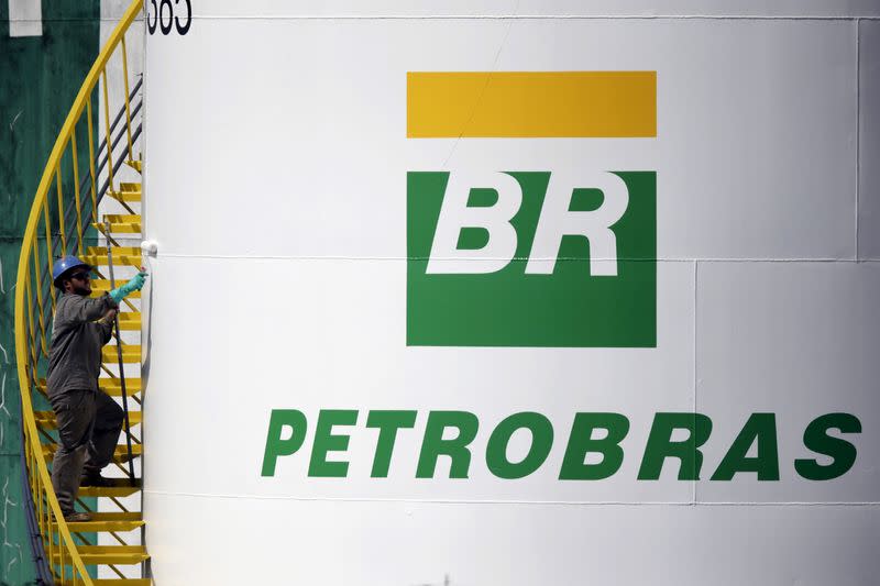 A worker paints a tank of Brazil's state-run Petrobras oil company in Brasilia