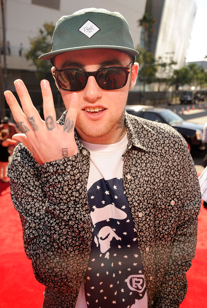 Pittsburgh-born rapper Mac Miller, who was featured on the remix of Maroon 5’s hit song “Moves Like Jagger,” showed off one of his many tattoos when he arrived at the show. In case you can’t read upside down, his right hand’s fingers spell out "most" … while his left reads “dope.”