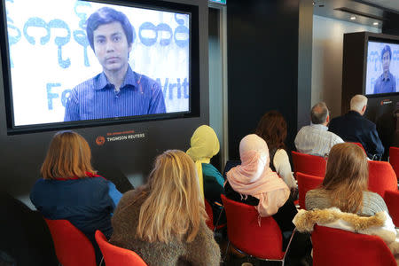 Guests at a panel discussion by Reuters and Committee to Protect Journalists executives watch a video about the detention of detained Reuters journalists Wa Lone and Kyaw Soe Oo in Myanmar, during a panel discussion in Toronto, Ontario, Canada February 12, 2018. REUTERS/Chris Helgren