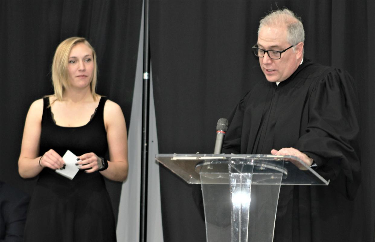 Marion County Court of Common Pleas FIRST Court graduate Kirsten Malone, left, listens as Judge W.T. Edwards talks about her accomplishments during the drug court graduation ceremony on Friday, April 29, 2022, at First Church of the Nazarene in downtown Marion. Malone was one of two graduates honored during the ceremony.