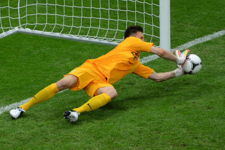 WARSAW, POLAND - JUNE 08: Przemyslaw Tyton of Poland saves Giorgos Karagounis of Greece's penalty during the UEFA EURO 2012 group A match between Poland and Greece at The National Stadium on June 8, 2012 in Warsaw, Poland. (Photo by Shaun Botterill/Getty Images)