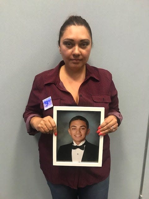 Vanesha Flores holds up a photo of her son Junior Angel Gonzalez after a town hall Wednesday addressing Ventura County's fentanyl crisis.