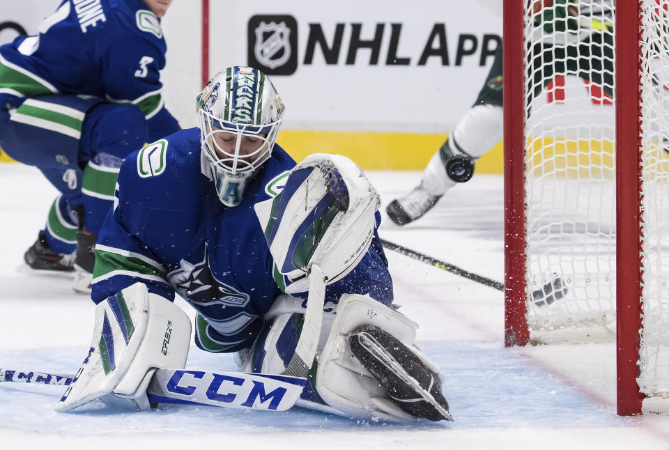 Vancouver Canucks goalie Thatcher Demko allows a goal to Minnesota Wild's Matt Dumba during the third period of an NHL hockey game, Tuesday, Oct. 26, 2021 in Vancouver, British Columbia. (Darryl Dyck/The Canadian Press via AP)