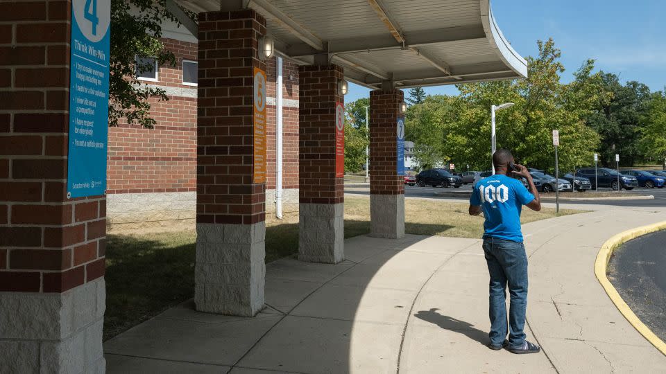 A father trying to pick up his child speaks on the phone in front of Fulton Elementary School after the school was evacuated following bomb threats on September 12, 2024. - Roberto Schmidt/AFP/Getty Images