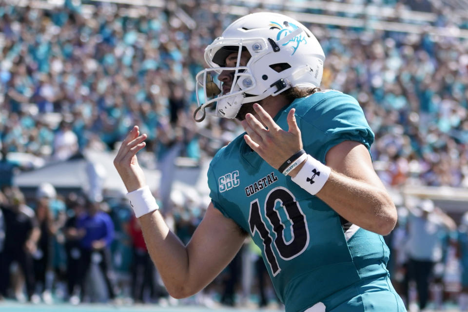 Coastal Carolina quarterback Grayson McCall celebrates after scoring during the first half of an NCAA college football game against Massachusetts on Saturday, Sept. 25, 2021, in Conway, S.C. (AP Photo/Chris Carlson)