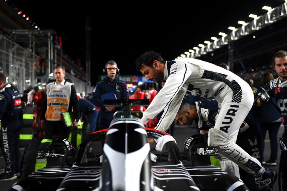 Daniel Ricciardo of Scuderia AlphaTauri jumps into his car on the grid (Getty)