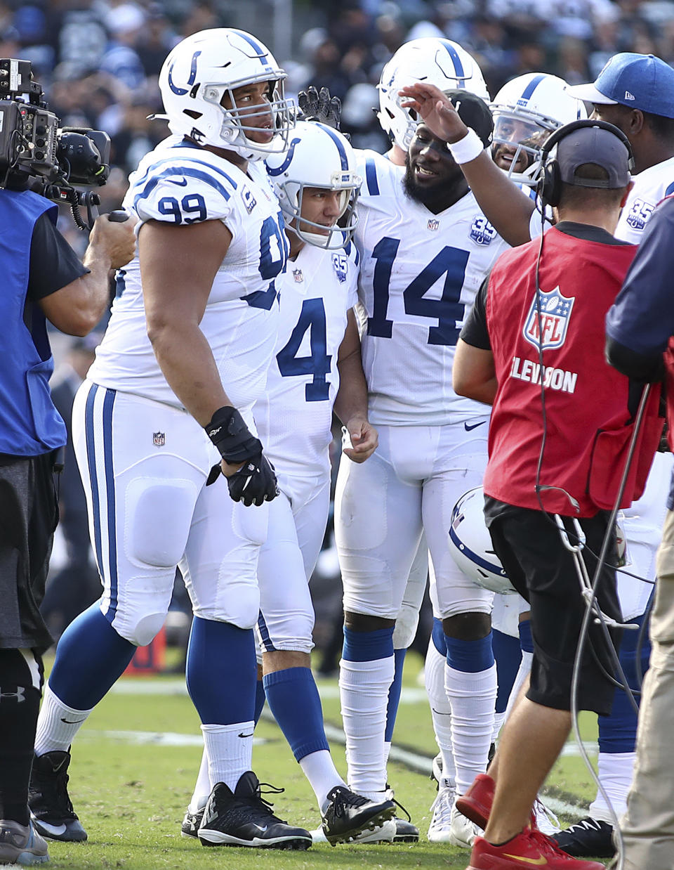 Indianapolis Colts kicker Adam Vinatieri (4) celebrates with teammates after kicking a field goal against the Oakland Raiders during the first half of an NFL football game in Oakland, Calif., Sunday, Oct. 28, 2018. Vinatieri surpassed Morten Andersen's NFL record for points with this kick. (AP Photo/Ben Margot)