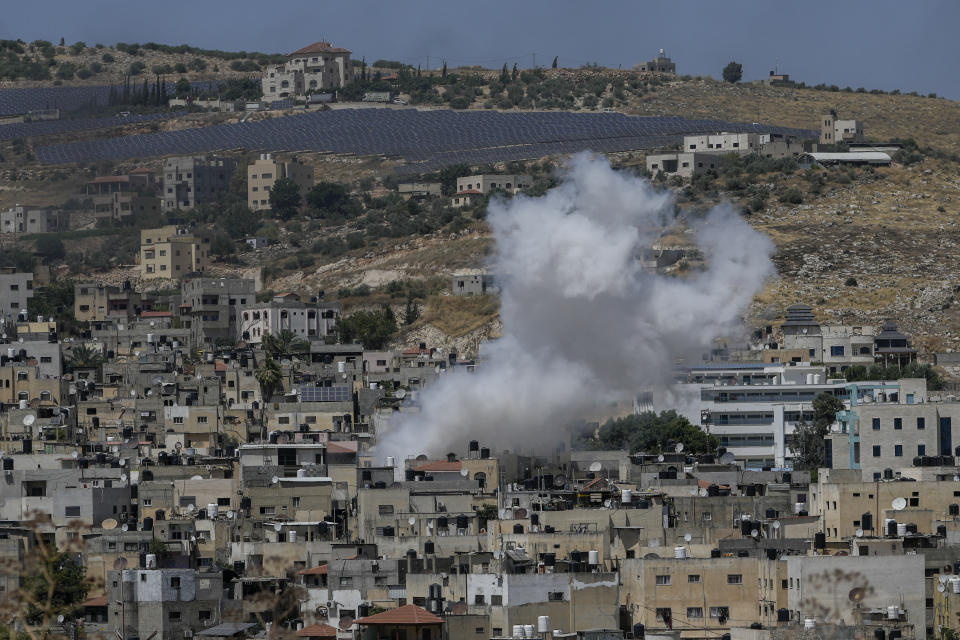 Smoke rises in the Palestinians Al Fara'a refugee camp in the occupied West Bank following an Israeli military raid, Monday, June 10, 2024. Israel's military killed a 15-year-old Palestinian in an overnight raid on Al Fara'a refugee camp in the occupied West Bank, according to Palestinian health officials. The military said Monday that it had begun what it described as a "counterterrorism" raid into the camp. It said soldiers killed one militant and injured two more with live fire and said the heavy exchanges of gunfire were ongoing. (AP Photo/Majdi Mohammed)