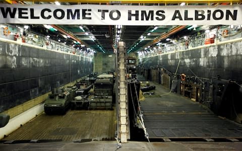 Military vehicles are seen in the loading dock of the HMS Albion, the British Royal Navy flagship amphibious assault ship, after the ship's arrival at Harumi Pier in Tokyo - Credit: Reuters