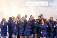 U.S. forward Catarina Macario, who won the SheBelieves Cup MVP award, hoists the SheBelieves Cup trophy while joined by teammates after their 5-0 win over Iceland in a soccer match Wednesday, Feb. 23, 2022, in Frisco, Texas. (AP Photo/Jeffrey McWhorter)