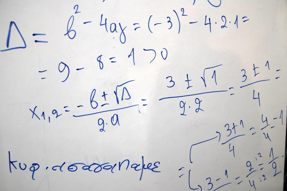 A phrase, bottom left, reads "Mrs we love you" written by an inmate on a board with mathematics at Avlona's prison school, north of Athens, Wednesday, Feb. 10, 2021. With Greece's schools shut due to the pandemic, all lessons have gone online. But the online world isn't within reach of everyone _ and particularly not within reach of the students of Avlona Special Youth Detention Center, where internet devices are banned by law from the cells. (AP Photo/Thanassis Stavrakis)