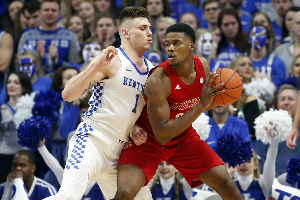 Louisville's Steven Enoch, right, looks for an opening on Kentucky's Nate Sestina during the first half of an NCAA college basketball game in Lexington, Ky., Saturday, Dec. 28, 2019. (AP Photo/James Crisp)