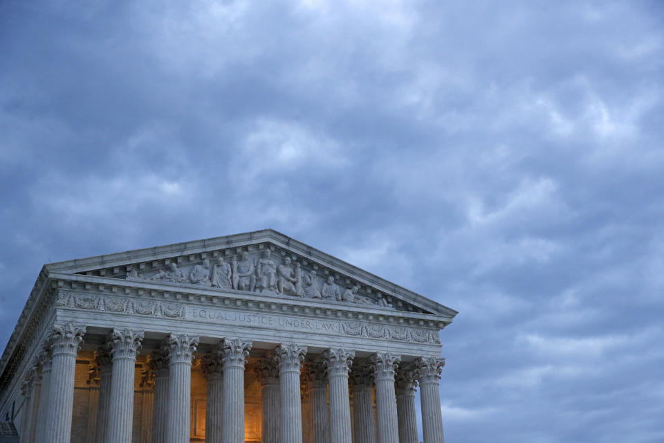 In this Sunday, May 3, 2020 photo, clouds roll over the Supreme Court at dusk on Capitol Hill in Washington. On Monday, May 4, the Supreme Court for the first time audio of court's arguments will be heard live by the world and the first arguments by telephone. (AP Photo/Patrick Semansky)