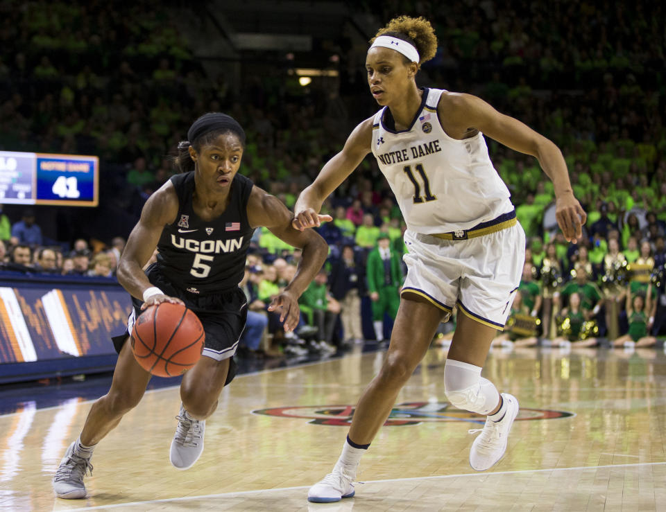 Connecticut's Crystal Dangerfield (5) drives by Notre Dame's Brianna Turner (11) during the first half of an NCAA college basketball game Sunday, Dec. 2, 2018, in South Bend, Ind. (AP Photo/Robert Franklin)