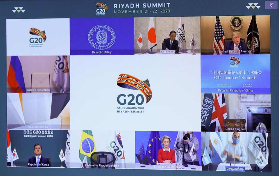 Japanese Prime Minister Yoshihide Suga (top L), US President Donald Trump (top R), South Korean President Moon Jae-in (down L), and European Commission President Ursula von der Leyen (down C) are seen on a screen before the start of a virtual G20 summit hosted by Saudi Arabia and held over video conference amid the Covid-19 (novel coronavirus) pandemic, in Brussels, on November 21, 2020. - Saudi Arabia hosts a G20 summit on November 21 and 22, in a first for an Arab nation, with the virtual forum dominated by efforts to tackle the coronavirus pandemic and the worst global recession in decades. (Photo by YVES HERMAN / POOL / AFP) (Photo by YVES HERMAN/POOL/AFP via Getty Images)