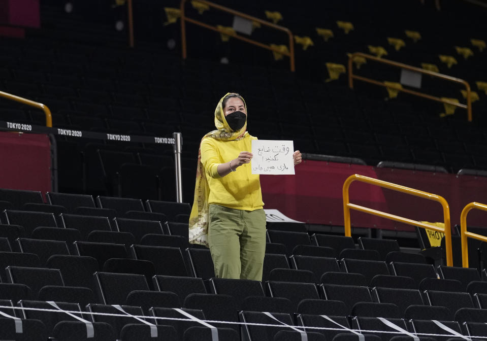 An Iran fan displays a paper during men's basketball game between Czech Republic and Iran at the 2020 Summer Olympics, Sunday, July 25, 2021, in Saitama, Japan. (AP Photo/Eric Gay)