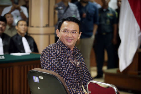 Jakarta's Governor Basuki Tjahaja Purnama smiles to the visitors inside the courtroom during his blasphemy trial at the North Jakarta District Court in Jakarta, Indonesia, December 27, 2016. REUTERS/Bagus Indahono/Pool