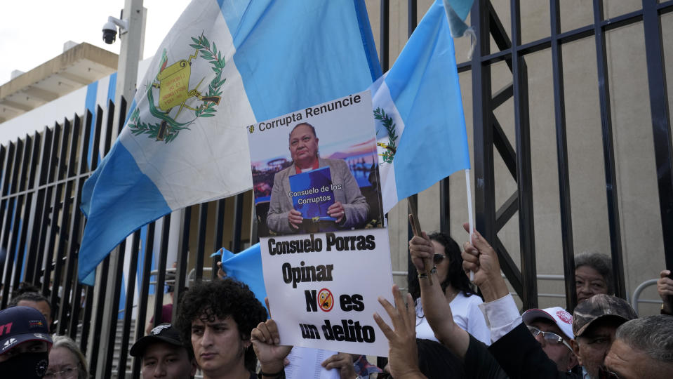 Protesters show documents with citizen signatures demanding the resignation of Attorney General Consuelo Porras, in Guatemala City, Friday, Sept. 1, 2023. President-elect Bernardo Arévalo named Porras, anti-corruption prosecutor Rafael Curruchiche and the judge who ordered his party's suspension as among those working to keep him from taking office. (AP Photo/Moises Castillo)